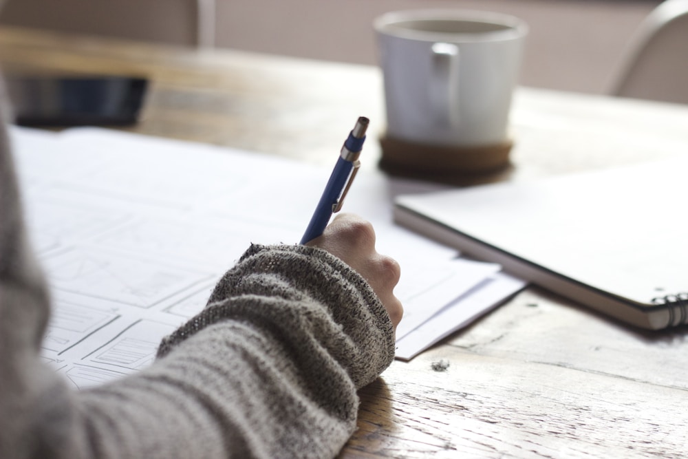 Man taking notes while reviewing male health information